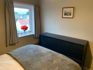 a bedroom with a bed and a window at Superb One Bedroom Getaway in Dysart Kirkcaldy in Kirkcaldy