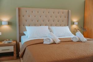a bedroom with a bed with towels on it at Sivota Seafront Studios in Sivota +19 photos