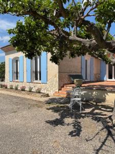 a chair sitting in front of a house at La Bastide des Launes près du Festival de Piano in La Roque-dʼAnthéron