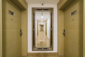 a hallway with a mirror on the wall at Hotel 219 Budva in Budva +38 photos