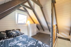 a bedroom in a tiny house with a bed at Hacienda-Dębina in Debina