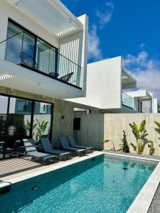 a villa with a swimming pool and a house at Elysian Blue villa 4 in Paphos City