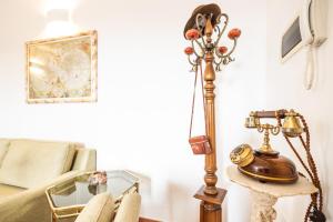 a room with a table with a lamp and a couch at Ravenna Retrò Vintage, City Flat 600 meters from the center in Ravenna