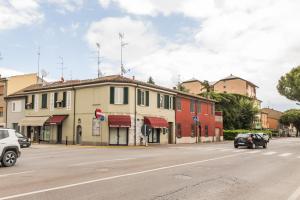 a building on a street with cars driving down the street at Ravenna Retrò Vintage, City Flat 600 meters from the center in Ravenna