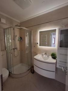 a bathroom with a shower and a sink and a toilet at Apartments Leona in Umag +9 photos