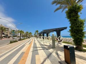 an empty street with a palm tree and the ocean at SA Apartments! Beachfront Apartments in Oba in Alanya +224 photos