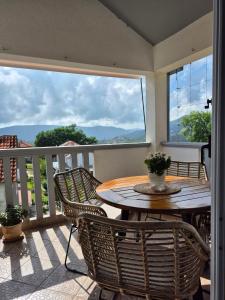 a table and chairs on a balcony with a view at Zorana in Herceg-Novi