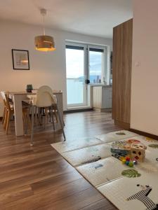 a living room with a dining room table and a kitchen at Sunny Apartment Bojnice in Bojnice