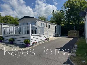 a large white trailer with a driveway at Kayes Retreat Three bed caravan Newquay Bay Resort Quieter area of park in Newquay