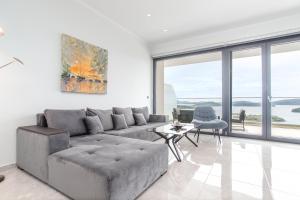 a living room with a couch and a table at Diamond Blue Villas Lefkada in Nydri