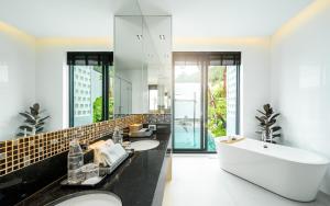a bathroom with two sinks and a large mirror at New 3BR Private Pool Villa with 5 Stars Resort Service in Rawai Beach
