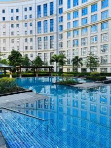 a large blue pool in front of a building at 81 Newport Studio C5 5i near NAIA T3 Pool and Balcony in Manila