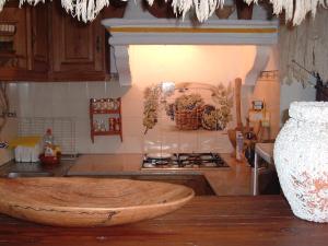 a kitchen with a wooden bowl on the counter at Heaven House in Sesimbra +22 photos