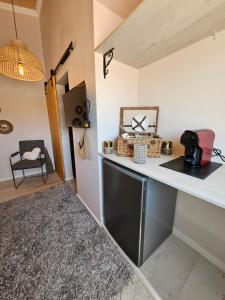 a kitchen with a counter top and a table at Portugals Infinity Eco Suite Resort in Tavira