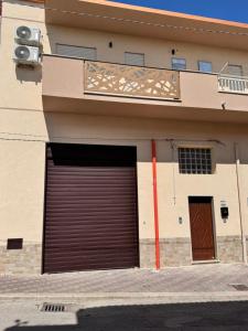 a building with a garage door on the side of it at HERMES Luxury Home in Agrigento +1 photo