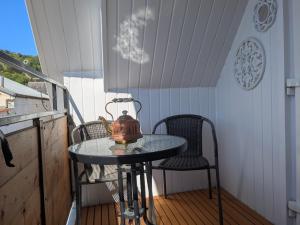 a tea kettle sitting on a table on a balcony at Nest Holiday Home Central Callander, Trossachs Self-catering in Callander