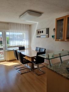 a dining room with a table and chairs in a room at Ferienwohnung Schamne in Wutöschingen