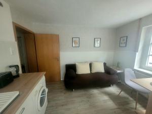 a living room with a couch and a table at Moderne Ferienwohnung in der Altstadt in Eschwege