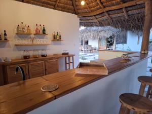 a bar in a room with a table and chairs at Beheloka Lodge in Ambalaviro