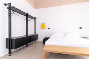 a bedroom with a bed and a wooden table at Casa Umbertina in La Spezia