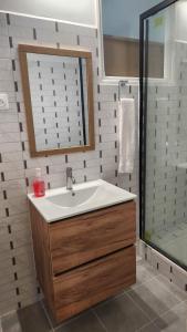 a bathroom with a sink and a shower at Flora Stains in Stains