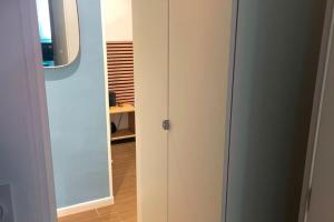 a white cabinet with a mirror in a room at Appartement centre historique in Hyères
