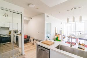 a kitchen with a sink and a counter top at CN Luxury Suites - Complementary Parking - Save on MONTHLY STAYS in Toronto