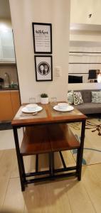 a table with two plates on it in a living room at 81 Newport Studio C5 5i near NAIA T3 Pool and Balcony in Manila