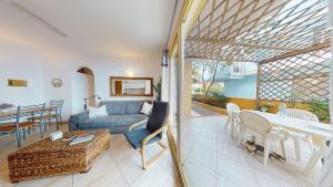 a living room with a couch and a table at Angulo Beach Orchidea in Santa Maria