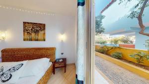 a bedroom with a bed and a balcony at Angulo Beach Orchidea in Santa Maria