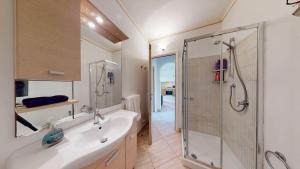 a bathroom with a shower and a sink and a tub at Angulo Beach Orchidea in Santa Maria