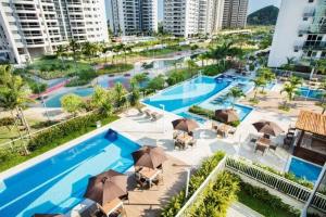 an overhead view of a swimming pool with umbrellas at Ilha Pura Barra in Rio de Janeiro +3 photos