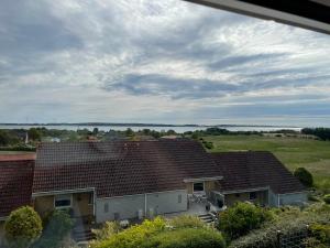 a group of houses with roofs and a field at Seaside Bed & Breakfast in Kalundborg