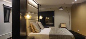 a bedroom with a bed and a large mirror at Pico Blue Ocean - Sea House in São Roque do Pico