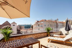 a balcony with a table and chairs and an umbrella at Roof top, close to Taksim, with private terrace in Istanbul +3 photos