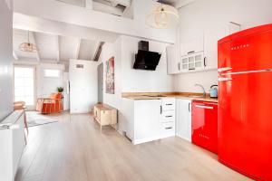 a kitchen with a red refrigerator and white cabinets at Roof top, close to Taksim, with private terrace in Istanbul