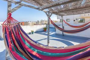 a pair of hammocks on top of a roof at Casa de Océano in Tarifa