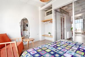 a bedroom with a bed and a chair and a mirror at Roof top, close to Taksim, with private terrace in Istanbul