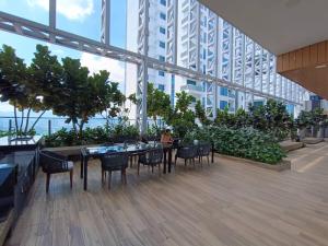 a dining area with tables and chairs in a building at The Luxe Colony KLCC by Sky Pool in Kuala Lumpur