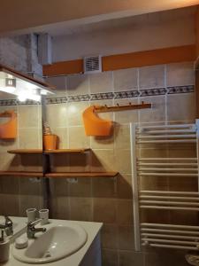 a bathroom with a sink and a shower at Le Charmant Duplex in Cognac