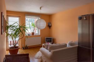 a living room with orange walls and a white couch at Apartmán Albrechtice in Albrechtice v Jizerských horách