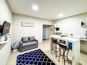 uma cozinha com balcão e cadeiras em uma sala em Vila Imper Host Balsas- Apês com Wi-fi I A/C a 3 min. do Mix Mateus em Balsas