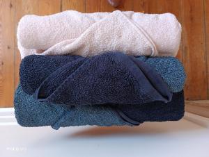 a pile of towels sitting on top of a table at Ostal Arriatge in Lézat-sur-Lèze +7 photos