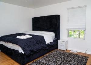 a bedroom with a large bed and a window at Anike's Place in Newark