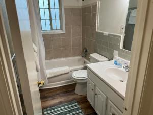 a bathroom with a toilet and a tub and a sink at Just Peachy 2BR 2BA Private Luxury Apartment in Atlanta +74 photos