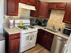 a kitchen with a white stove and a sink at Just Peachy 2BR 2BA Private Luxury Apartment in Atlanta