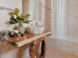 a bathroom with a sink and a bath tub at Coastal Garden Paradise Retreat- 6 min from the beach in Charneca