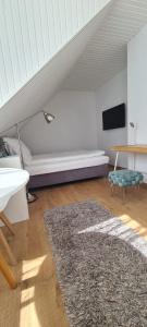 a living room with a bed and a rug at Tim's City Apartments in Hannover