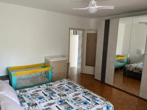 a bedroom with a bed and a dresser and a mirror at Appartamento Trifoglio in Salò