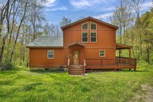 a large orange house in the middle of a field at Secluded 3BR Home Fire Pit Covered Deck in Salamanca
